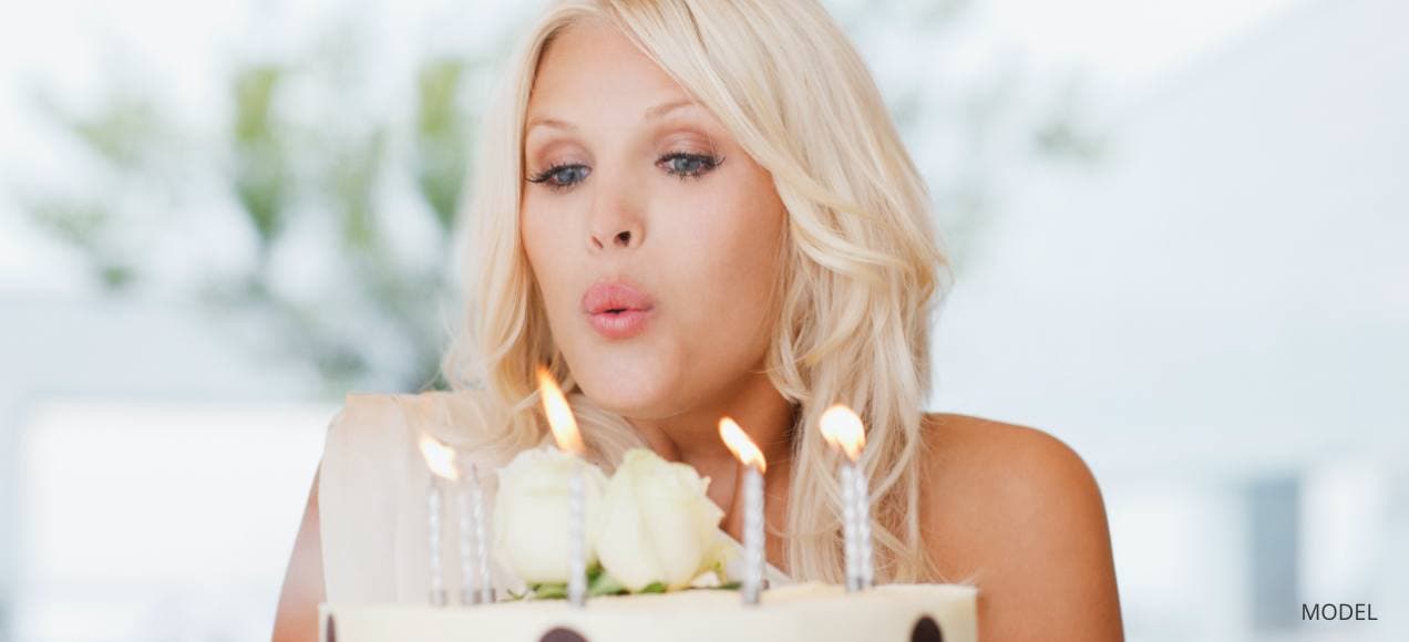 Woman blowing out birthday candles